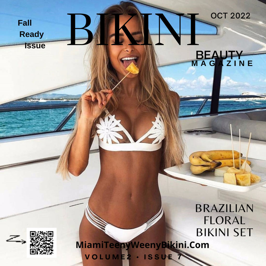 Woman on yacht wearing white floral bikini set, holding fruit, ocean in background