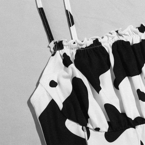 Women's bikini top with black and white cow print, ruched detailing, thin straps