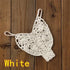White crochet bikini thong bottom on wooden background, women's swimwear.