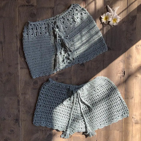 Crochet bikini cover-up skirts with tassel ties on wood, beach swimwear accessory