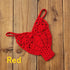 Red crochet bikini top with intricate pattern on wooden background