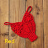 Red crochet bikini top with intricate pattern on wooden background