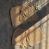 Beige crochet knit bikini cover up skirts with tassel ties, laid on wooden surface