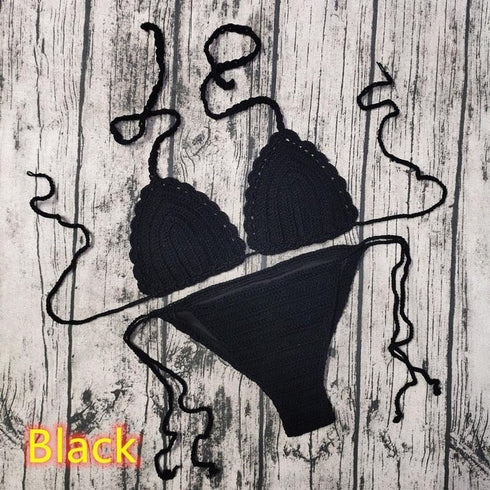Black crochet bikini set with tie straps on rustic wooden background, women's swimwear