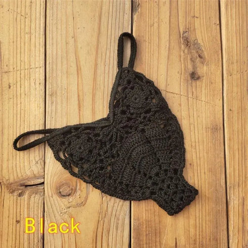 Black crochet bikini thong bottom with floral pattern on wooden background
