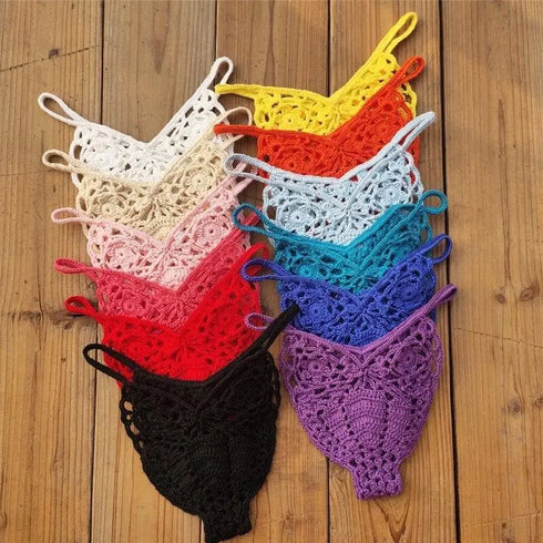 Colorful crochet bikini thong bottoms arranged on wooden surface