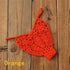 Orange crochet bikini bottom on wooden background, swimwear for women