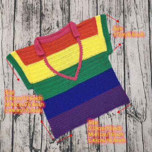 Colorful crochet rainbow striped knit crop top with size measurements on wood background