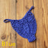 Blue crochet bikini bottom with floral pattern on wooden surface