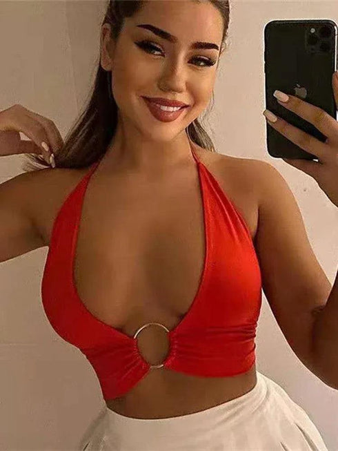 Woman in a red halter bikini top with ring detail taking a selfie indoors