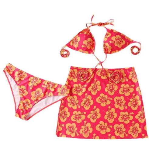 Women's floral bikini set with matching skirt in pink and yellow hibiscus print
