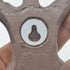 Close-up of a metallic gear with a central hole, held by a hand against a white background.