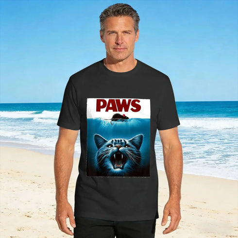 Man wearing a black t-shirt with 'PAWS' graphic on a beach