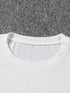 White t-shirt collar on a gray carpet background