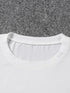 White t-shirt collar on a gray carpet background
