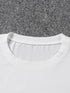 White t-shirt collar on a gray carpet background