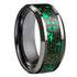 Ring with green and black intricate design on a white background