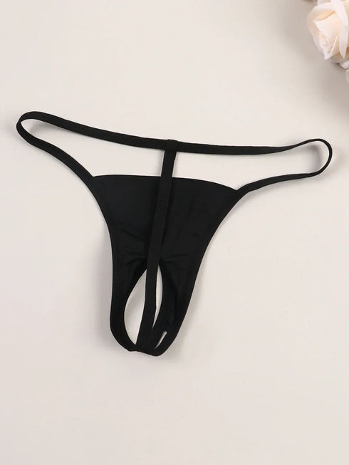 Black thong on a light beige background