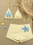 Beige bikini set with blue starfish designs on a brown background