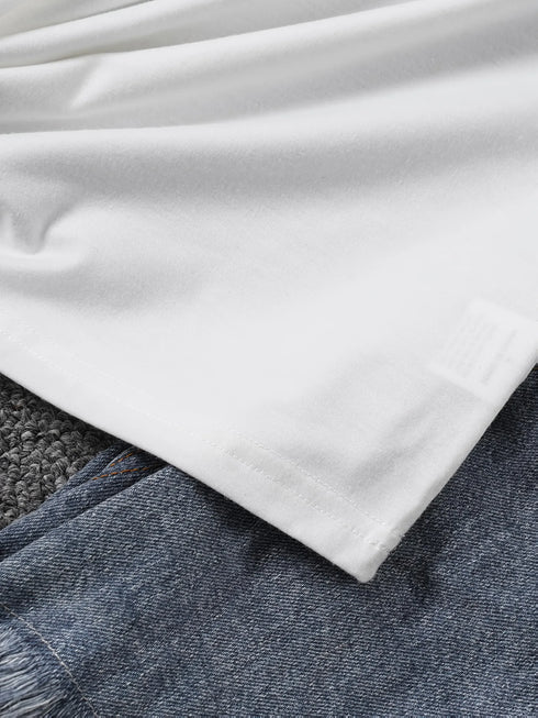 Close-up of white fabric on top of denim fabric