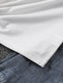 Close-up of white fabric on top of denim fabric