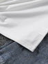Close-up of white fabric on top of denim fabric