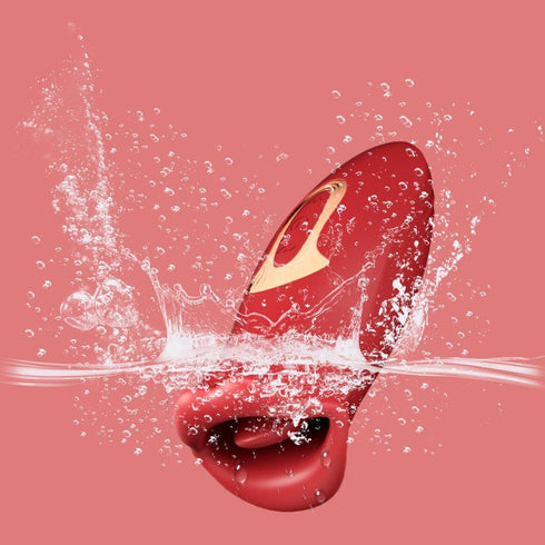 Red waterproof personal massager with gold detail splashing in water on pink background